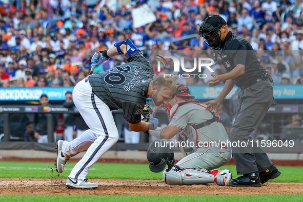 Pete Alonso #20 of the New York Mets is hit by a pitch during the seventh inning of the baseball game against the Philadelphia Phillies at C...