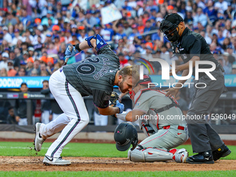 Pete Alonso #20 of the New York Mets is hit by a pitch during the seventh inning of the baseball game against the Philadelphia Phillies at C...