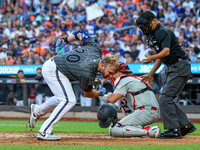 Pete Alonso #20 of the New York Mets is hit by a pitch during the seventh inning of the baseball game against the Philadelphia Phillies at C...