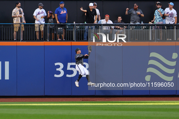 New York Mets left fielder Brandon Nimmo #9 makes a catch against the wall during the seventh inning of the baseball game against the Philad...