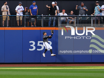 New York Mets left fielder Brandon Nimmo #9 makes a catch against the wall during the seventh inning of the baseball game against the Philad...