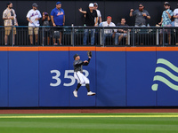 New York Mets left fielder Brandon Nimmo #9 makes a catch against the wall during the seventh inning of the baseball game against the Philad...