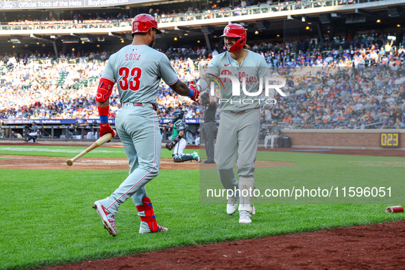 Nick Castellanos #8 of the Philadelphia Phillies is congratulated after homering during the fifth inning of a baseball game against the New...