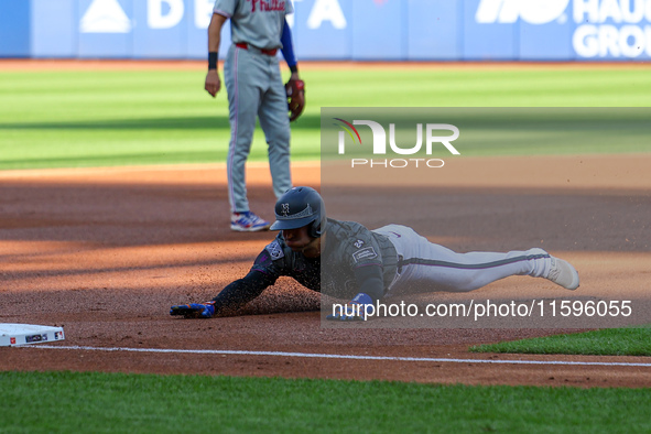 Jose Iglesias #11 of the New York Mets slides into third base during the first inning of the baseball game against the Philadelphia Phillies...