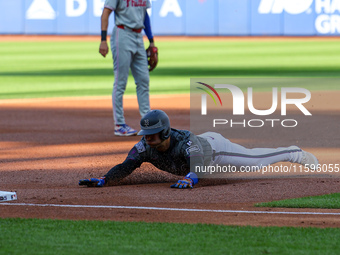 Jose Iglesias #11 of the New York Mets slides into third base during the first inning of the baseball game against the Philadelphia Phillies...