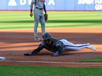 Jose Iglesias #11 of the New York Mets slides into third base during the first inning of the baseball game against the Philadelphia Phillies...