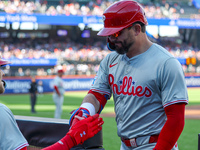 Philadelphia Phillies' Kyle Schwarber #12 is congratulated after homering during the first inning of a baseball game against the New York Me...