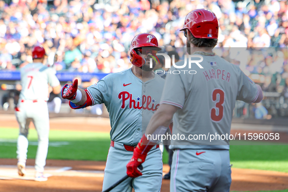 Philadelphia Phillies' Kyle Schwarber #12 is congratulated after homering during the first inning of a baseball game against the New York Me...