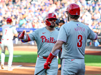 Philadelphia Phillies' Kyle Schwarber #12 is congratulated after homering during the first inning of a baseball game against the New York Me...