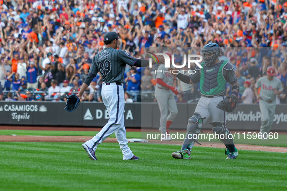 New York Mets relief pitcher Edwin Diaz #39 and catcher Francisco Alvarez #4 celebrate the Mets' 6-2 win in the baseball game against the Ph...