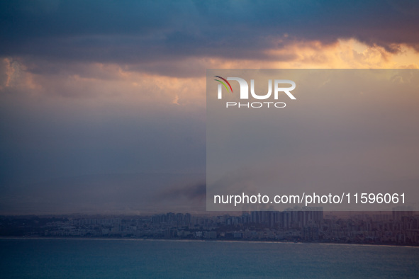 Smoke rises in a suburb north of the city of Haifa, Israel, following the apparent strike of a rocket fired from Lebanon on September 22, 20...