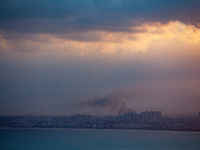 Smoke rises in a suburb north of the city of Haifa, Israel, following the apparent strike of a rocket fired from Lebanon on September 22, 20...