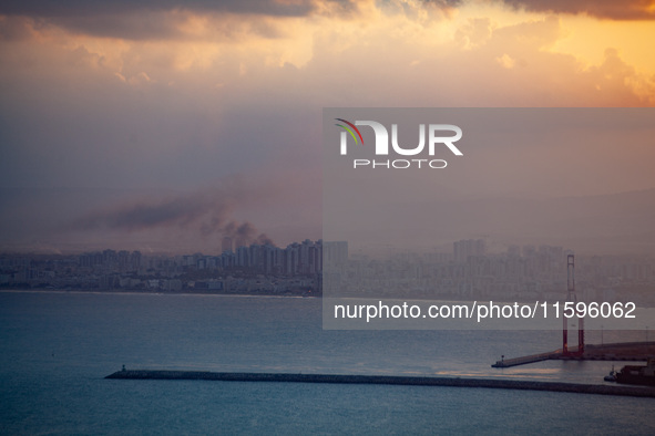 Smoke rises in a suburb north of the city of Haifa, Israel, following the apparent strike of a rocket fired from Lebanon on September 22, 20...