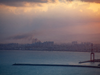 Smoke rises in a suburb north of the city of Haifa, Israel, following the apparent strike of a rocket fired from Lebanon on September 22, 20...