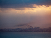 Smoke rises in a suburb north of the city of Haifa, Israel, following the apparent strike of a rocket fired from Lebanon on September 22, 20...