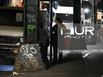 Police investigate the crime scene where a 26-year-old man is shot in the Highland Park section of Brooklyn, New York, United States, on Sep...