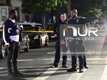 Police investigate the crime scene where a 26-year-old man is shot in the Highland Park section of Brooklyn, New York, United States, on Sep...