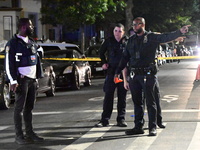 Police investigate the crime scene where a 26-year-old man is shot in the Highland Park section of Brooklyn, New York, United States, on Sep...