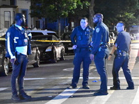 Police investigate the crime scene where a 26-year-old man is shot in the Highland Park section of Brooklyn, New York, United States, on Sep...