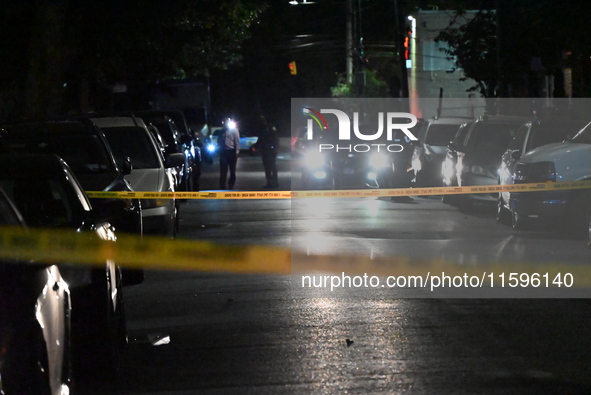 Police investigate the crime scene where a 26-year-old man is shot in the Highland Park section of Brooklyn, New York, United States, on Sep...