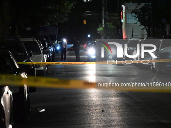 Police investigate the crime scene where a 26-year-old man is shot in the Highland Park section of Brooklyn, New York, United States, on Sep...