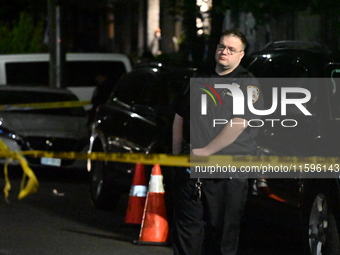 Police investigate the crime scene where a 26-year-old man is shot in the Highland Park section of Brooklyn, New York, United States, on Sep...