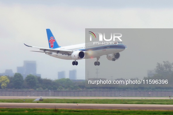 The first C919 passenger plane of China Southern Airlines prepares to land on the runway at Hangzhou Xiaoshan International Airport after ar...