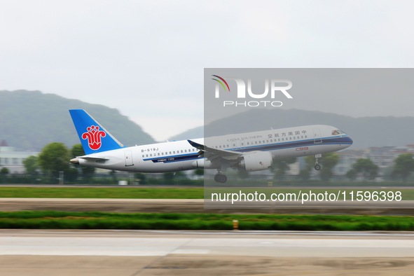 The first C919 passenger plane of China Southern Airlines prepares to land on the runway at Hangzhou Xiaoshan International Airport after ar...