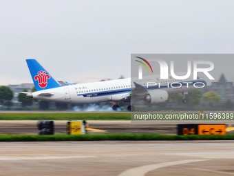 The first C919 passenger plane of China Southern Airlines prepares to land on the runway at Hangzhou Xiaoshan International Airport after ar...