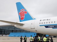 Airport ground staff check the C919 passenger plane of China Southern Airlines after it arrives at Hangzhou Xiaoshan International Airport f...