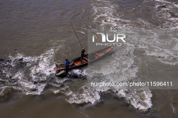 Fishermen catch fish in the river Jhelum in Sopore, Jammu and Kashmir, India, on September 22, 2024. 