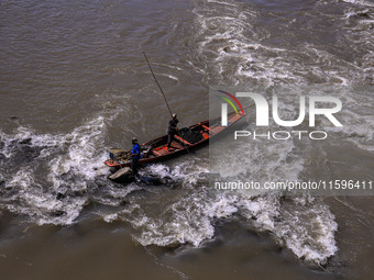 Fishermen catch fish in the river Jhelum in Sopore, Jammu and Kashmir, India, on September 22, 2024. (