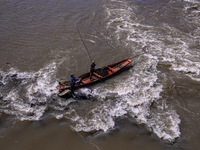 Fishermen catch fish in the river Jhelum in Sopore, Jammu and Kashmir, India, on September 22, 2024. (