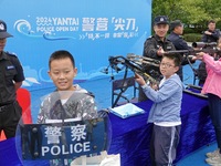 A child experiences police firearms and equipment at the Open Day of a police camp in Yantai, China, on September 21, 2024. (