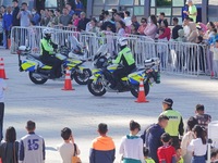 Traffic policemen demonstrate their driving skills on a police motorcycle during the Open Day of the police camp of Yantai Public Security B...