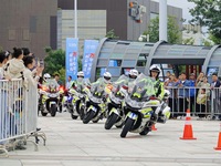 Traffic policemen demonstrate their driving skills on a police motorcycle during the Open Day of the police camp of Yantai Public Security B...