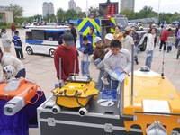 Citizens look at new intelligent police equipment at the Open Day of the police camp of Yantai Public Security Bureau in Yantai, China, on S...