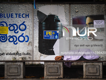 A man sleeps at the bus stop in Colombo, Sri Lanka, on September 22, 2024. A curfew is imposed in Sri Lanka amid the counting of votes in th...