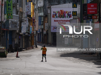 A laborer walks on the empty street in Colombo, Sri Lanka, on September 22, 2024. Curfew is imposed in Sri Lanka amid the counting of votes...