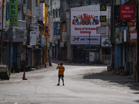 A laborer walks on the empty street in Colombo, Sri Lanka, on September 22, 2024. Curfew is imposed in Sri Lanka amid the counting of votes...