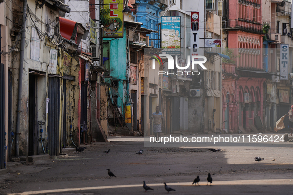 A man walks on the empty street in Colombo, Sri Lanka, on September 22, 2024. A curfew is imposed in Sri Lanka amid the counting of votes in...