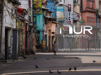 A man walks on the empty street in Colombo, Sri Lanka, on September 22, 2024. A curfew is imposed in Sri Lanka amid the counting of votes in...