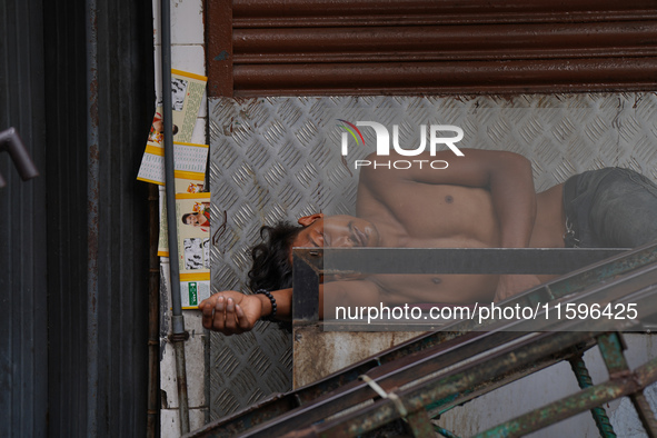 A man sleeps on the cart in Colombo, Sri Lanka, on September 22, 2024. A curfew is imposed in Sri Lanka amid the counting of votes in the pr...