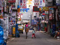 A family walks on the empty street in Colombo, Sri Lanka, on September 22, 2024. A curfew is imposed in Sri Lanka amid the counting of votes...