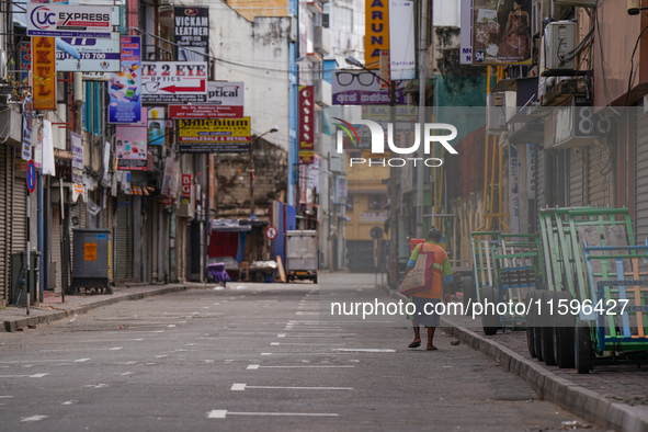 A woman walks on the empty street in Colombo, Sri Lanka, on September 22, 2024. A curfew is imposed in Sri Lanka amid the counting of votes...