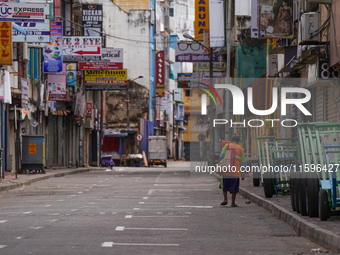 A woman walks on the empty street in Colombo, Sri Lanka, on September 22, 2024. A curfew is imposed in Sri Lanka amid the counting of votes...