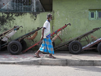 A man walks in front of the carts during the curfew time in Colombo, Sri Lanka, on September 22, 2024. Curfew is imposed in Sri Lanka amid t...