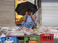 A street vendor takes a call from his mobile phone during the curfew period in Colombo, Sri Lanka, on September 22, 2024. Curfew is imposed...