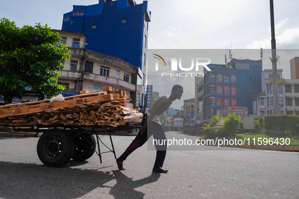 A laborer pulls a cart in Colombo, Sri Lanka, on September 22, 2024. A curfew is imposed in Sri Lanka amid the counting of votes in the pres...