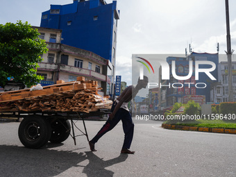 A laborer pulls a cart in Colombo, Sri Lanka, on September 22, 2024. A curfew is imposed in Sri Lanka amid the counting of votes in the pres...